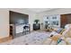 Comfortable living room boasts wood floors, a large television, and plenty of seating at 163 Periwinkle Pl, Clayton, NC 27527