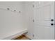 Hallway with bench seating, hooks, and a white door at 163 Periwinkle Pl, Clayton, NC 27527