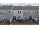 Townhome backyards with sliding glass doors, small patios, and minimal landscaping at 175 Norwell Ln, Pittsboro, NC 27312