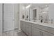 Bathroom featuring double sink vanity with gray cabinets, quartz countertops, and modern lighting at 175 Norwell Ln, Pittsboro, NC 27312