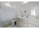 Bright bathroom with double sink vanity, quartz countertops, and neutral shower curtain at 175 Norwell Ln, Pittsboro, NC 27312