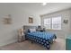Neutral bedroom with a gray bed, desk, and window for lots of natural light at 175 Norwell Ln, Pittsboro, NC 27312