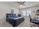 Neutral bedroom featuring a bed with blue comforter, ceiling fan and lots of natural light at 175 Norwell Ln, Pittsboro, NC 27312