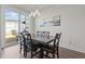Dining room featuring a dark wood table, modern lighting, and a large window at 175 Norwell Ln, Pittsboro, NC 27312