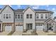 Beautiful townhome featuring a two-car garage, manicured lawn, and modern architectural details at 175 Norwell Ln, Pittsboro, NC 27312