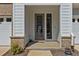 Inviting front porch featuring a gray trim and door and brick accents at 175 Norwell Ln, Pittsboro, NC 27312