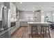 Open concept kitchen with stainless appliances, central island, and hardwood floors at 175 Norwell Ln, Pittsboro, NC 27312