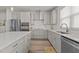 Bright kitchen featuring stainless steel appliances, gas range, and designer countertops at 175 Norwell Ln, Pittsboro, NC 27312