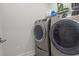 Laundry room featuring modern, front-loading washer and dryer at 175 Norwell Ln, Pittsboro, NC 27312