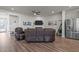 Open concept living space with modern furniture, stainless steel refrigerator, and hardwood floors at 175 Norwell Ln, Pittsboro, NC 27312