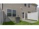 Backyard features a fenced yard, AC Unit, and back door entrance to the home at 176 Starlight St, Sanford, NC 27330