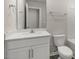 Bathroom featuring a white sink, vanity, and toilet at 176 Starlight St, Sanford, NC 27330