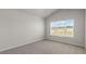 Bedroom featuring neutral carpet, vaulted ceiling and large window at 176 Starlight St, Sanford, NC 27330