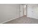 Neutral carpeted bedroom featuring a double door closet and minimalist design at 176 Starlight St, Sanford, NC 27330