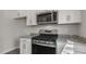 Modern kitchen with stainless steel appliances and gray granite countertops at 176 Starlight St, Sanford, NC 27330