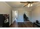 This bedroom has wood floors, a ceiling fan, and a mirrored closet at 1930 Maple Sugar Ln, Fuquay Varina, NC 27526