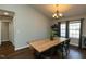 Cozy dining room with hardwood floors, modern chandelier, and large window with natural light at 1930 Maple Sugar Ln, Fuquay Varina, NC 27526