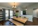 Bright dining area featuring a modern light fixture, wood floors, and a view of the front entry at 1930 Maple Sugar Ln, Fuquay Varina, NC 27526