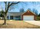 Charming single-story home with brick accents, a covered porch, and attached two-car garage at 1930 Maple Sugar Ln, Fuquay Varina, NC 27526