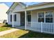 This home features a covered front porch with a white picket fence at 1930 Maple Sugar Ln, Fuquay Varina, NC 27526