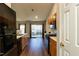 Bright kitchen features warm wood cabinets, modern appliances, and sliding glass door to the backyard at 1930 Maple Sugar Ln, Fuquay Varina, NC 27526