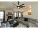 Bright living room with fireplace, hardwood floors, and vaulted ceiling with fan at 1930 Maple Sugar Ln, Fuquay Varina, NC 27526