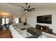 Open-concept living room with a large sectional, hardwood floors, and a view of the dining area at 1930 Maple Sugar Ln, Fuquay Varina, NC 27526