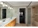 Bathroom featuring double sinks, a tiled shower, and a view into the main bedroom at 1930 Maple Sugar Ln, Fuquay Varina, NC 27526