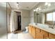 Bathroom featuring double sinks, a walk-in shower, and a walk-in closet at 1930 Maple Sugar Ln, Fuquay Varina, NC 27526