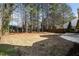 Large, fenced backyard with mature trees and a patio area at 209 Tullich Way, Holly Springs, NC 27540