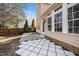 Backyard patio featuring new white paver stones and a grassy area at 209 Tullich Way, Holly Springs, NC 27540