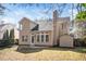 View of the rear elevation shows the back patio and spacious yard at 209 Tullich Way, Holly Springs, NC 27540