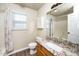 Bathroom with granite countertops, wood cabinets, and a combination shower/tub at 209 Tullich Way, Holly Springs, NC 27540
