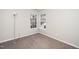 Bedroom featuring neutral carpet, white walls, and large windows at 209 Tullich Way, Holly Springs, NC 27540