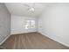 Bedroom features neutral carpet, white walls, and a window offering natural light at 209 Tullich Way, Holly Springs, NC 27540