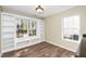 Bright dining room featuring built-in shelving, expansive window with views, and stylish wood-look flooring for modern living at 209 Tullich Way, Holly Springs, NC 27540