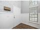 Bright entryway featuring stylish brick accent wall, white wainscoting, and durable wood-look flooring with a welcoming atmosphere at 209 Tullich Way, Holly Springs, NC 27540