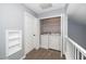 Laundry room area with white washer and dryer, white walls, and neutral carpet at 209 Tullich Way, Holly Springs, NC 27540