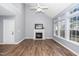 Living room features high ceilings, wood floors, a fireplace with white mantle, and large windows for natural light at 209 Tullich Way, Holly Springs, NC 27540
