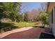 A landscaped backyard with a patio and lush green grass at 212 W University Dr, Chapel Hill, NC 27516
