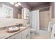 Bathroom with mosaic tile, classic sink, and retro-patterned wallpaper at 212 W University Dr, Chapel Hill, NC 27516