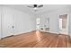 Bright bedroom with wood paneling, hardwood floors, and access to other rooms in the house at 212 W University Dr, Chapel Hill, NC 27516