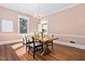 Dining room boasts hardwood floors, chandelier, and plenty of natural light at 212 W University Dr, Chapel Hill, NC 27516