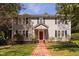 Charming two-story home with a brick pathway and manicured lawn at 212 W University Dr, Chapel Hill, NC 27516