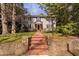 Charming two-story home with a brick pathway leading to the front door at 212 W University Dr, Chapel Hill, NC 27516
