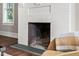 Close-up of the fireplace, highlighting the decorative brick and metalwork at 212 W University Dr, Chapel Hill, NC 27516