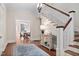 Welcoming foyer with hardwood floors, staircase, and stylish console table at 212 W University Dr, Chapel Hill, NC 27516