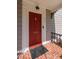 Elegant red front door with gold hardware and brick entryway at 212 W University Dr, Chapel Hill, NC 27516