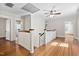 Hallway with hardwood floors, white banister, and access to multiple rooms and bathrooms at 212 W University Dr, Chapel Hill, NC 27516