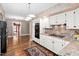 Bright kitchen features white cabinetry, granite countertops, and modern appliances at 212 W University Dr, Chapel Hill, NC 27516